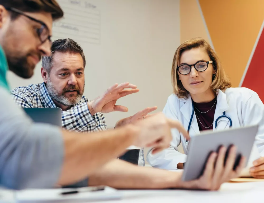 Health care workers reviewing copywriting on a tablet