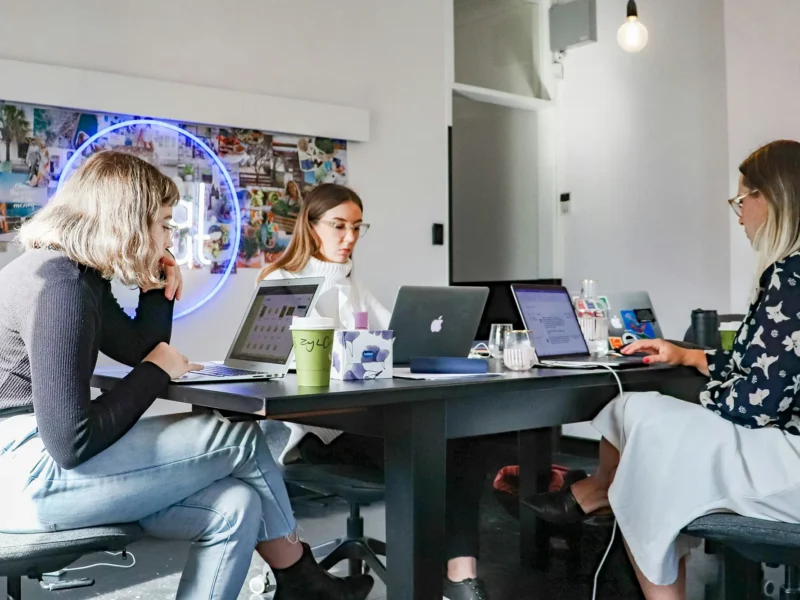 Marketing agency employees working around a desk.