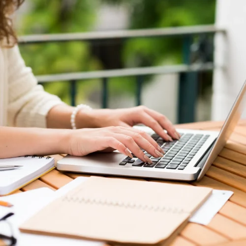 Close up of hands typing on a laptop