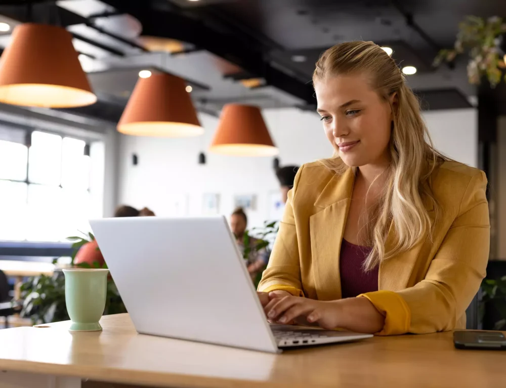 Woman typing on a laptop in an office