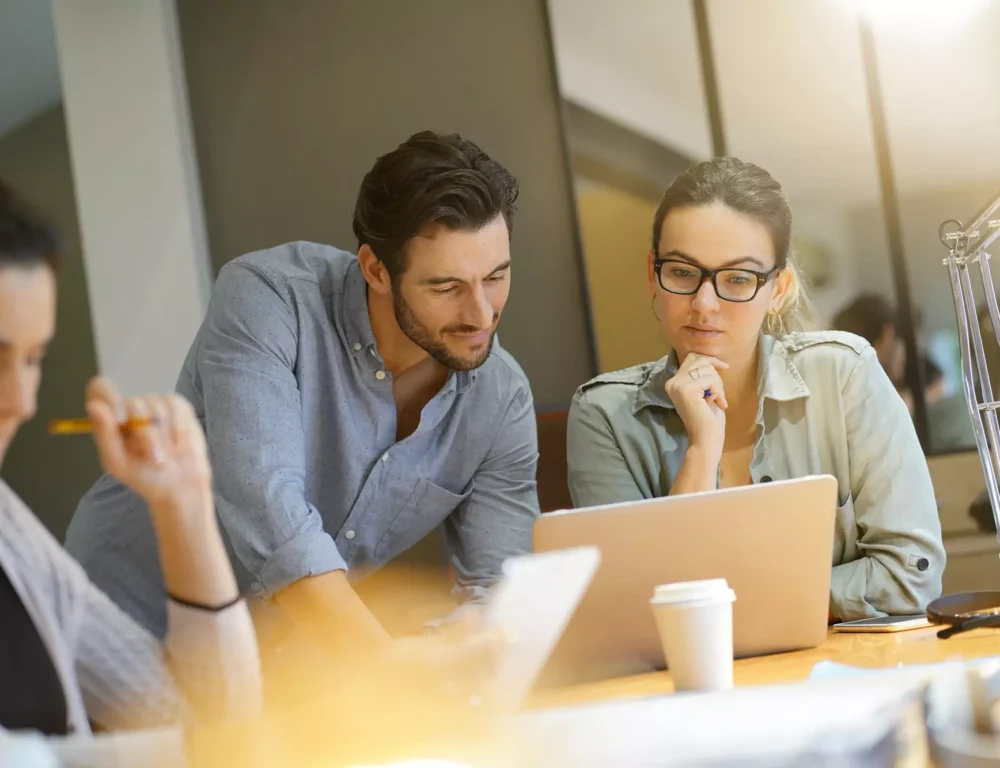 Man and woman reviewing copywriting on a laptop