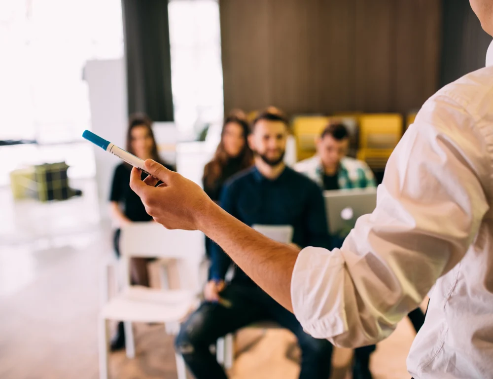 Man giving training session to a crowd of people