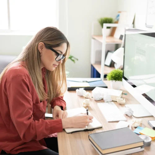 Woman making notes while doing a content audit